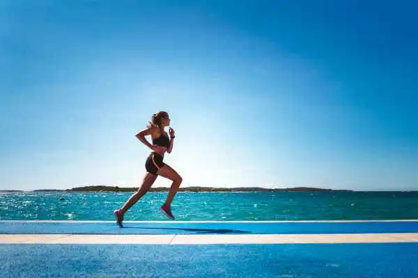 Woman running showing strong leg muscle Blackburn